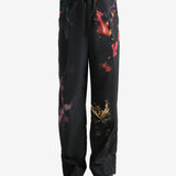 Black pants worn by a person, showing the pants' fit