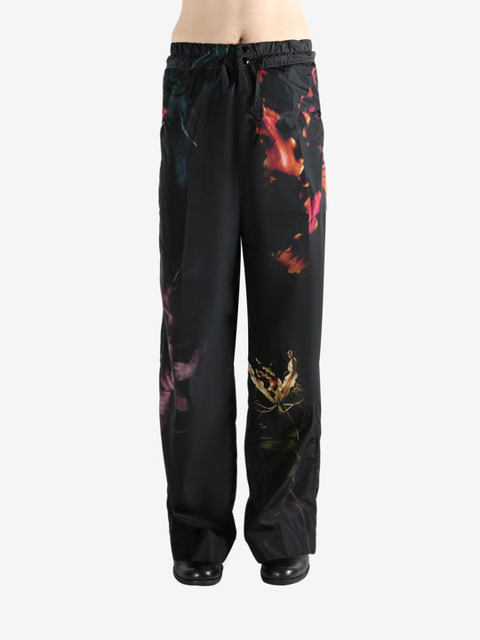 Black pants worn by a person, showing the pants' fit