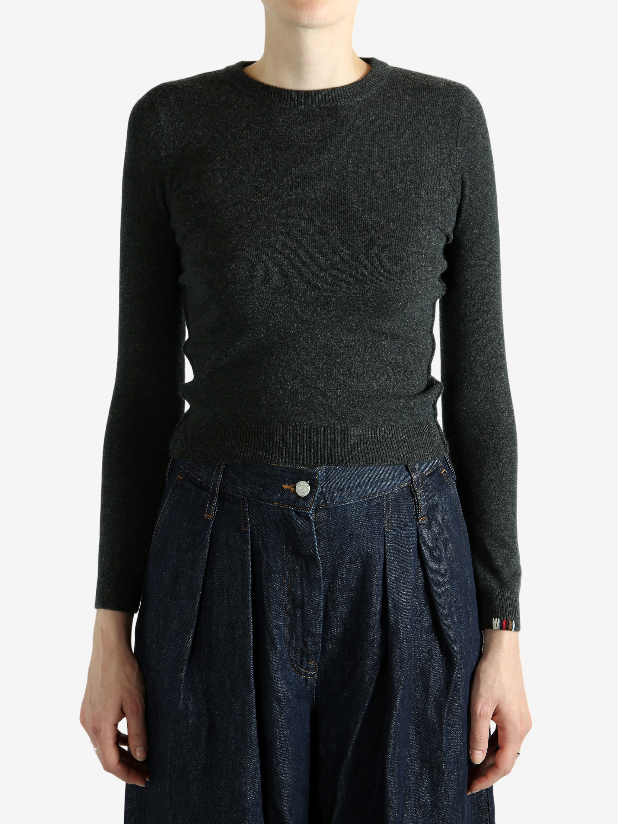 Grey sweater worn by a person, showing the sweater's fit