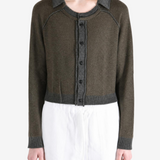 Green top worn by a person, showing the top fit