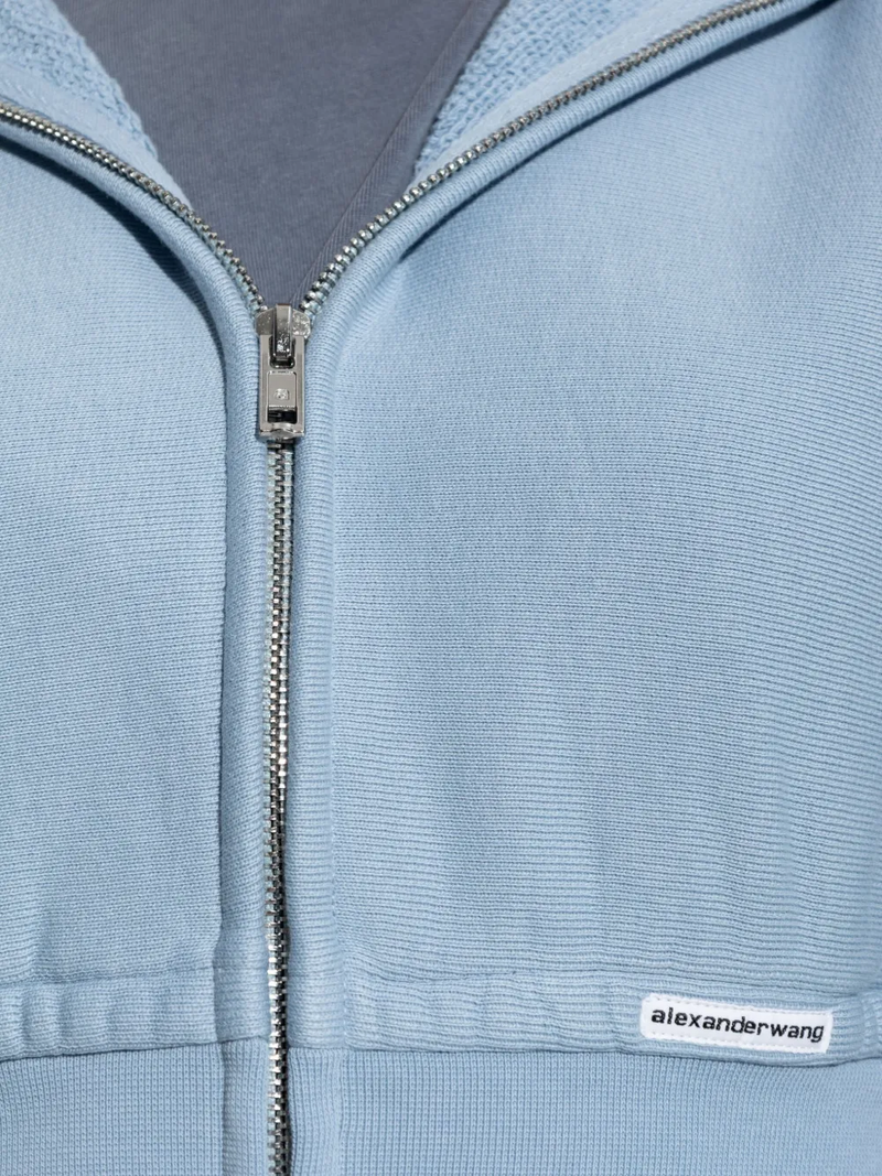 Close up of blue hoodie,showing texture of the cotton fabric.