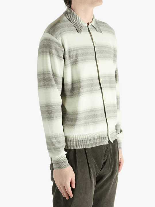 Green sweater worn by a person, showing the sweater's fit