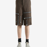 Brown shorts worn by a person, showing the shorts' fit