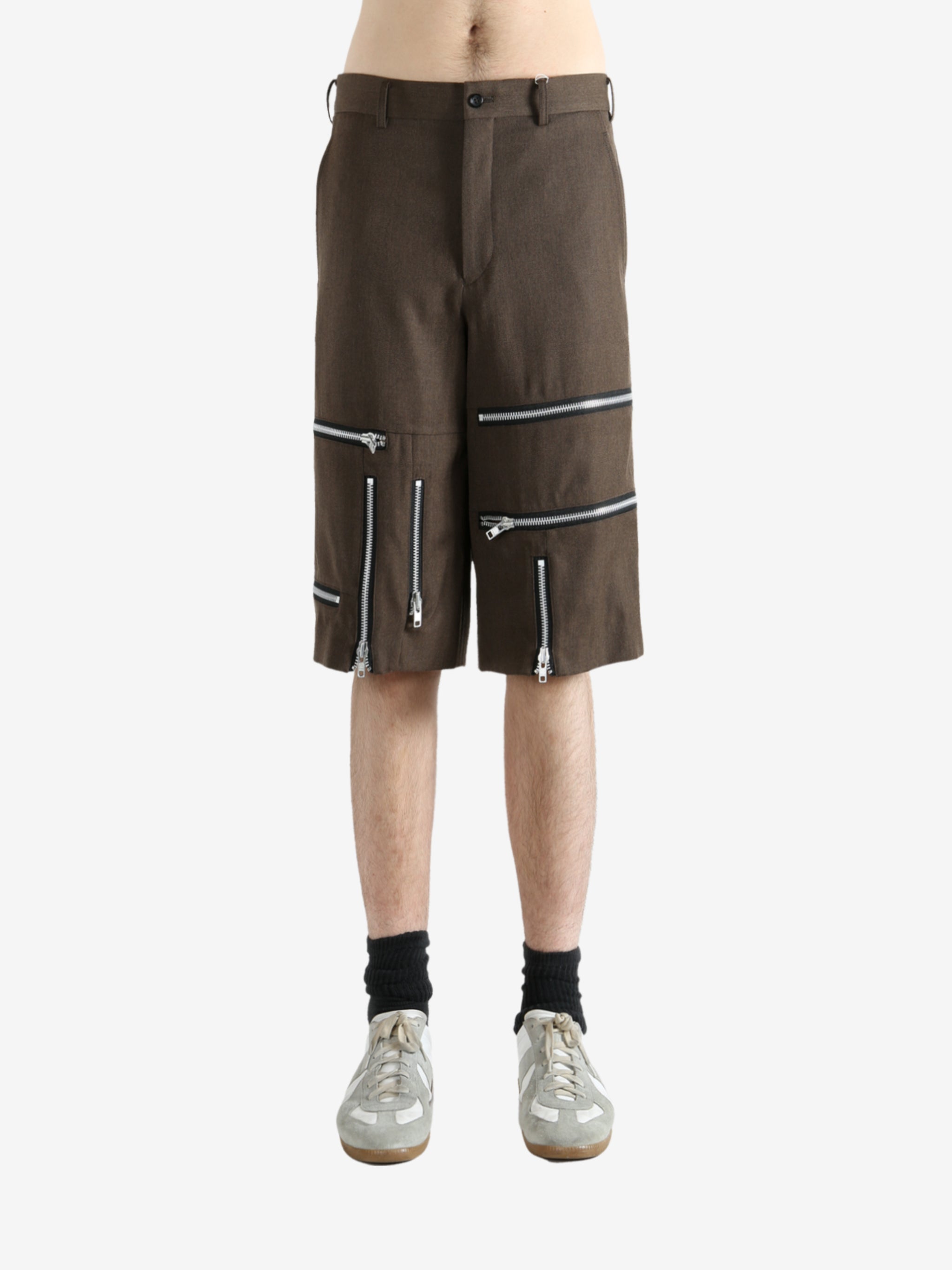 Brown shorts worn by a person, showing the shorts' fit