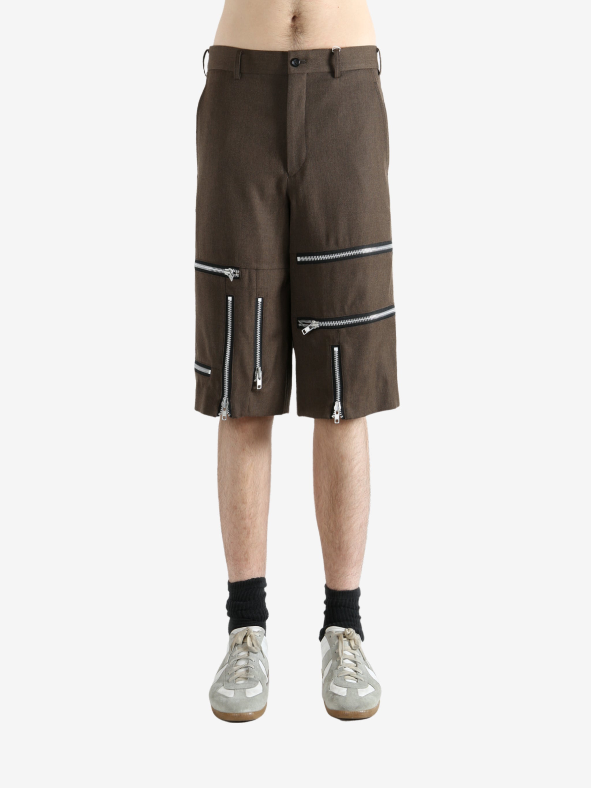 Brown shorts worn by a person, showing the shorts' fit