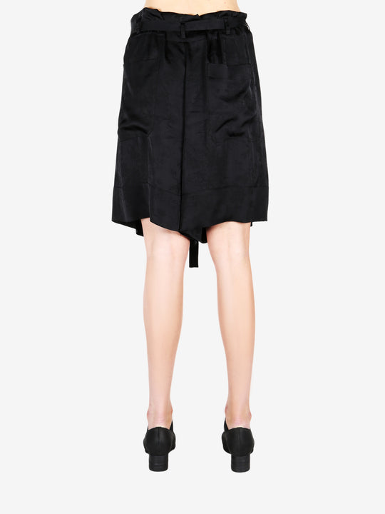 Black pant worn by a person, showing the shirt fit