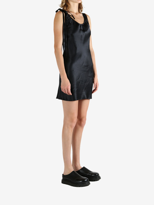 Black dress worn by a person, showing the dress's fit