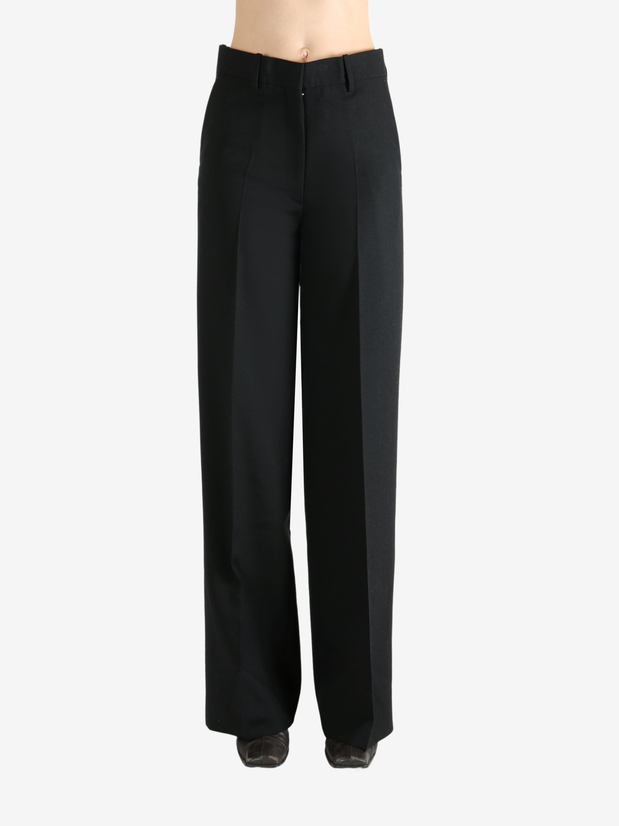 Black pants worn by a person, showing the pants' fit