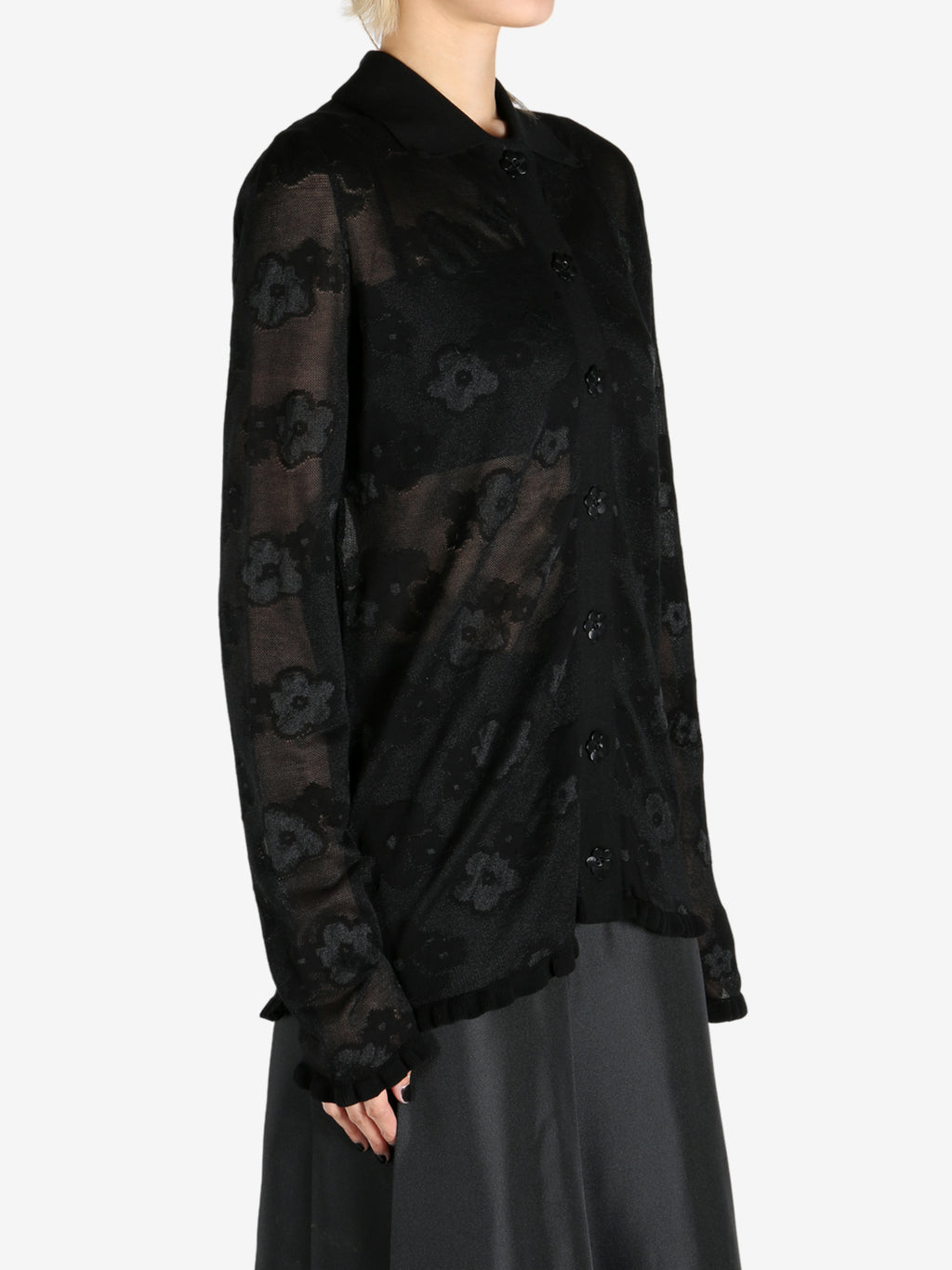 Black cardigan worn by a person, showing the cardigan's fit