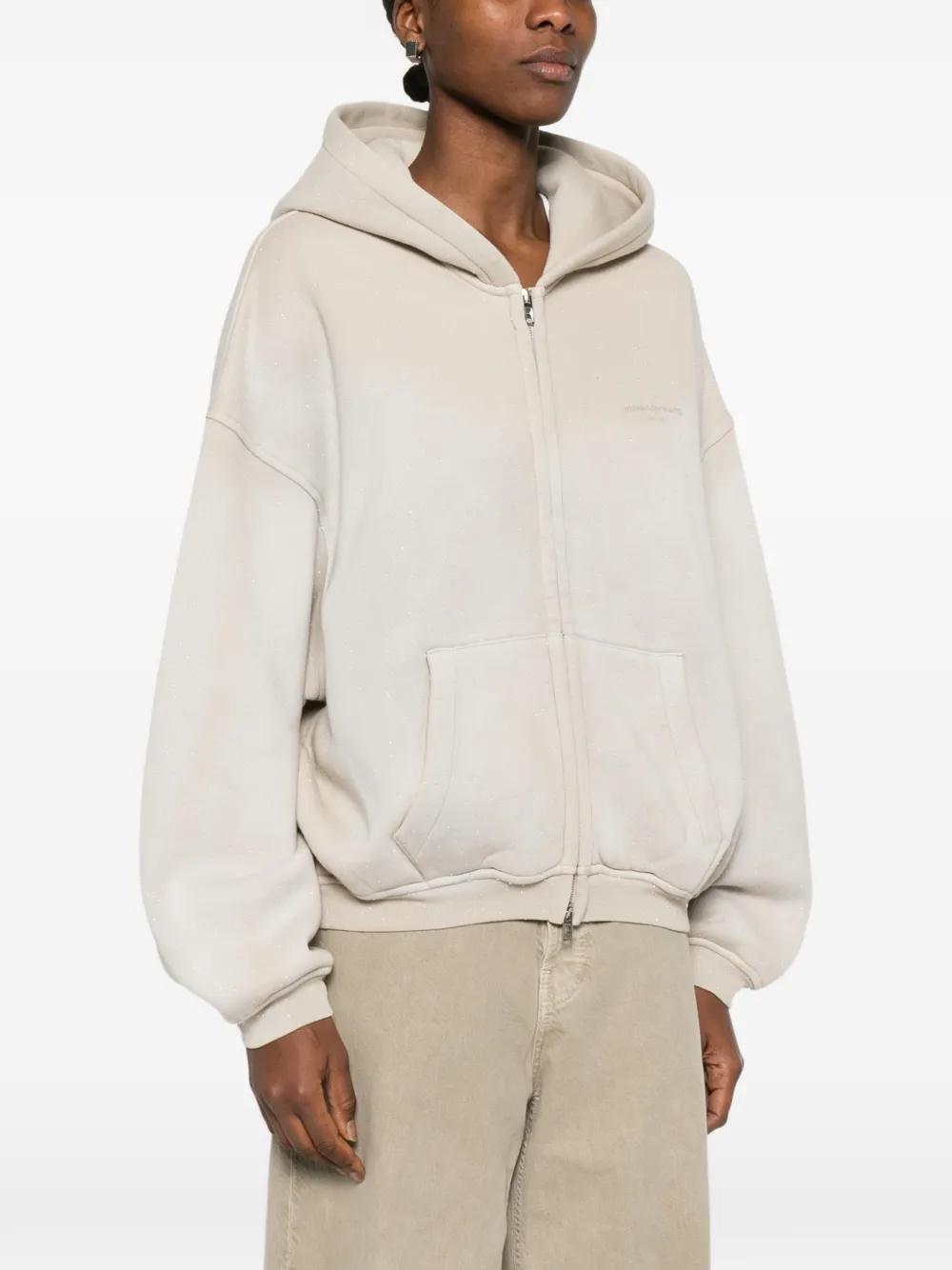 Tan hoodie worn by a person, showing the hoodie fit