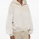 Tan hoodie worn by a person, showing the hoodie fit