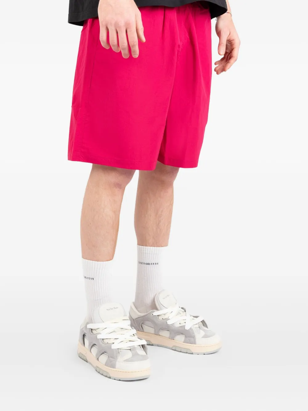 Pink shorts worn by a person, showing the shorts fit