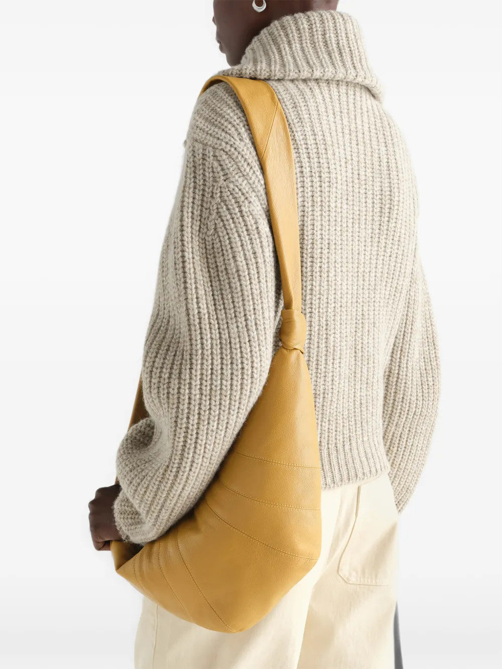 Tan bag worn by a person, showing the bag fit