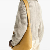 Tan bag worn by a person, showing the bag fit
