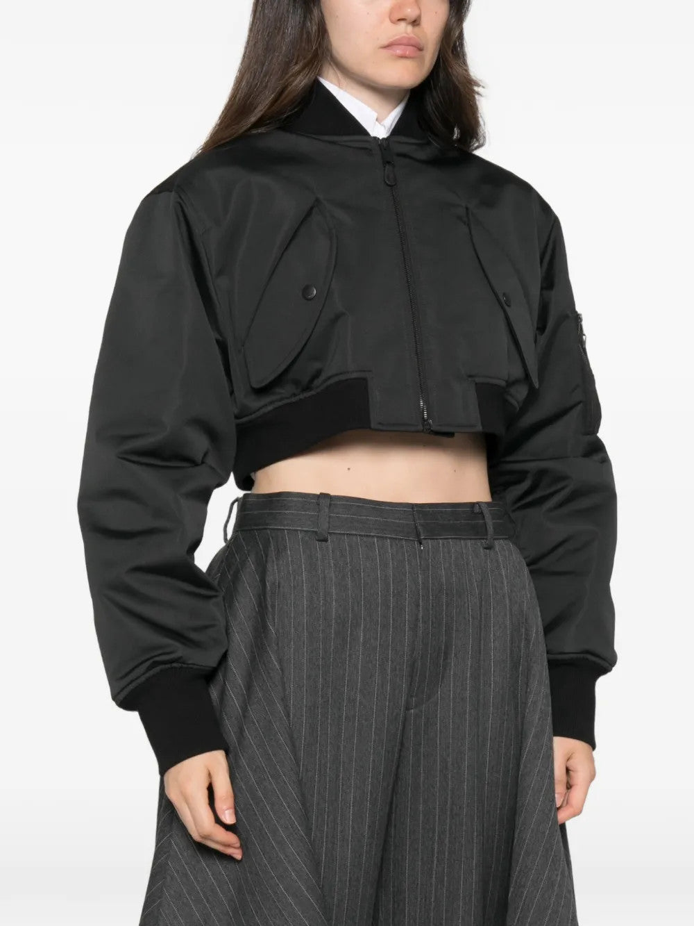 Black jacket worn by a person, showing the jacket fit