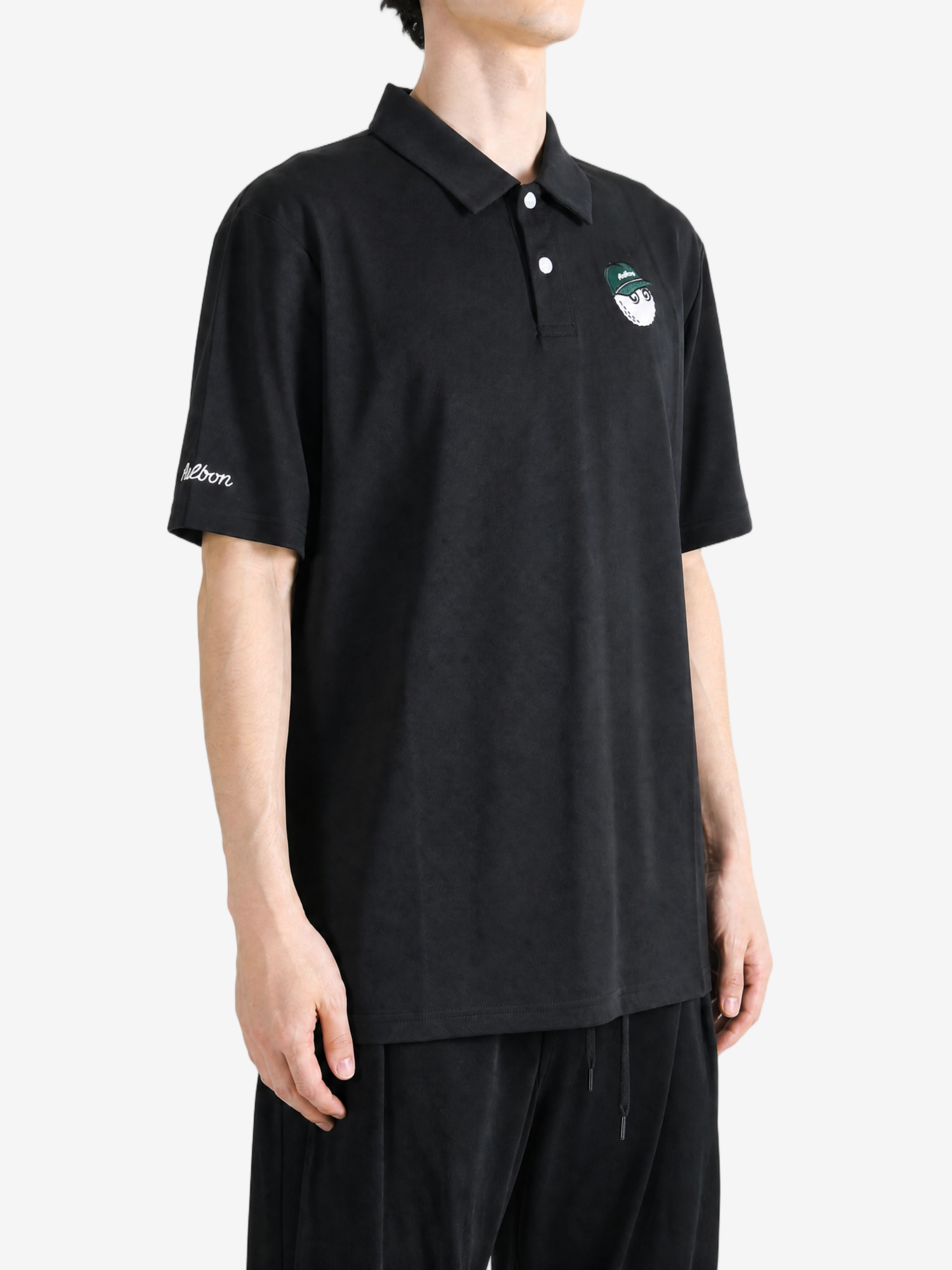 Black shirt worn by a person, showing the shirt fit