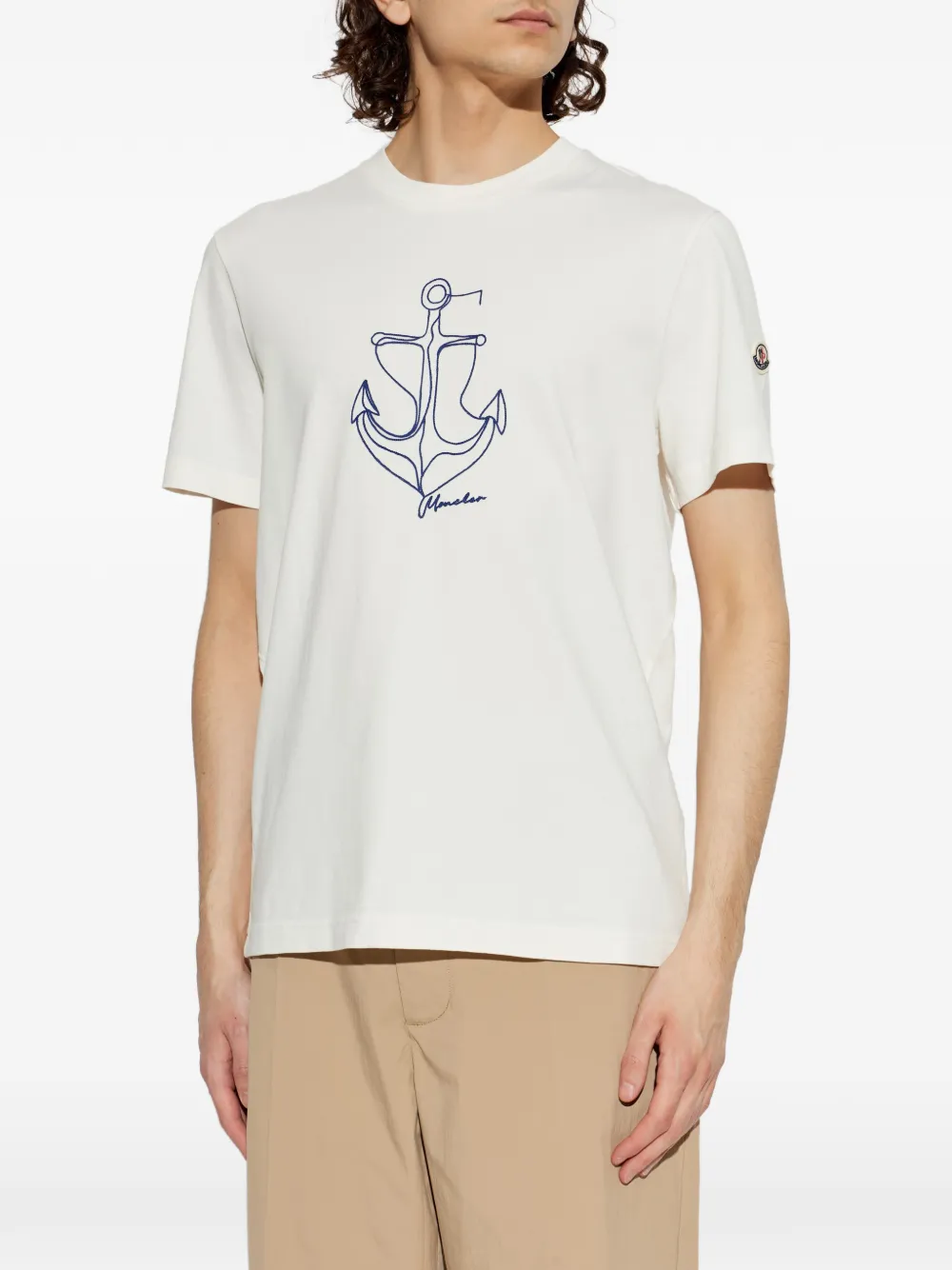 White t-shirt worn by a person, showing the t-shirt's fit