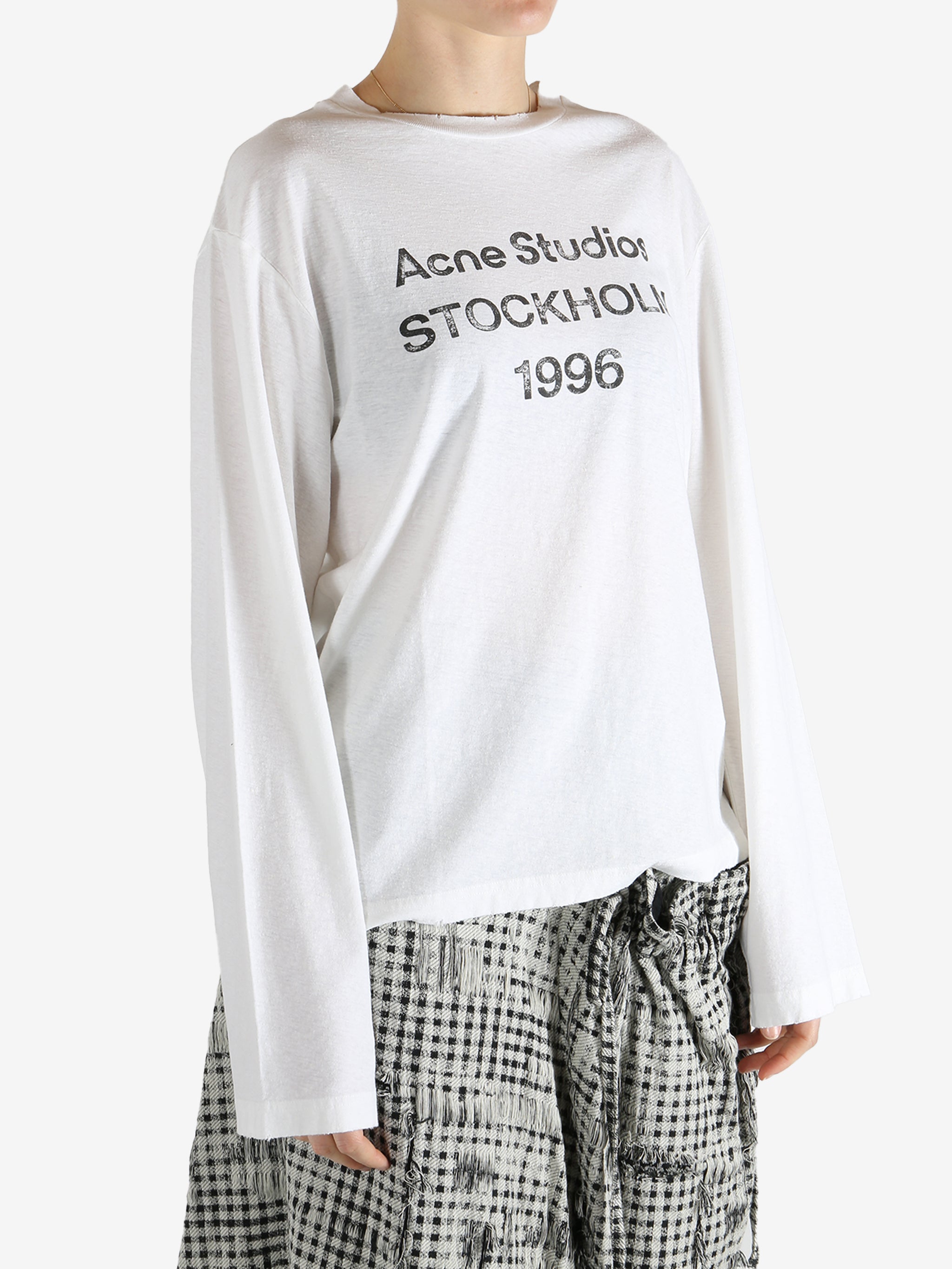 White t-shirt worn by a person, showing the t-shirt fit