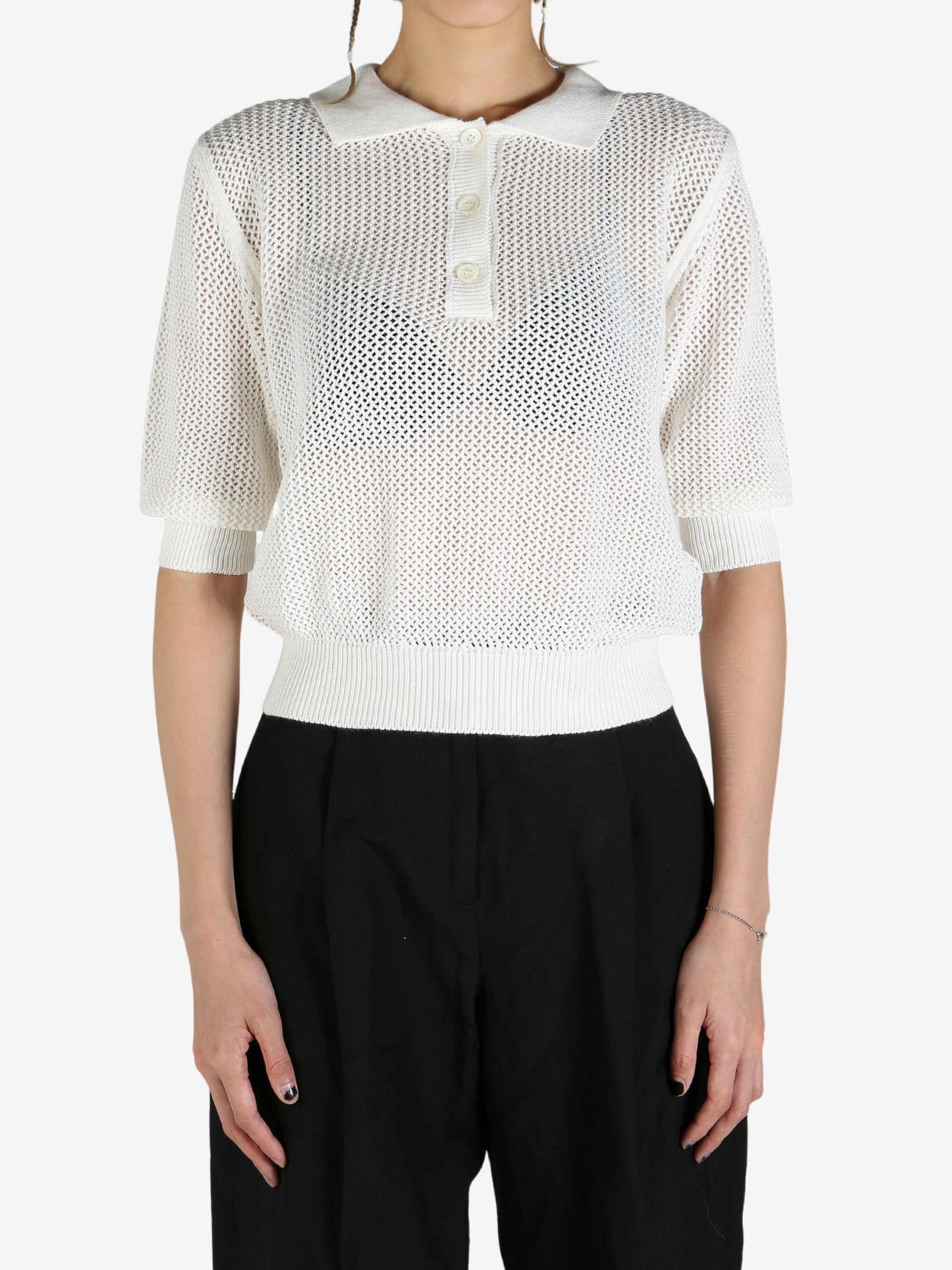 White shirt worn by a person, showing the shirt's fit