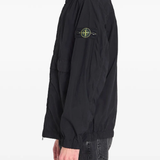 Black jacket worn by a person, showing the black jacket's fit