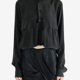 Black shirt worn by a person, showing the shirt's fit