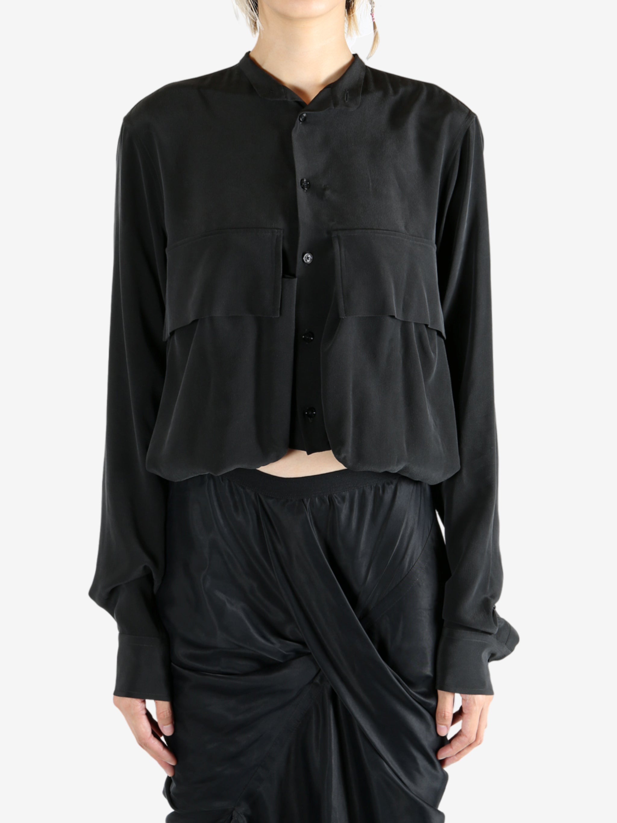 Black shirt worn by a person, showing the shirt's fit