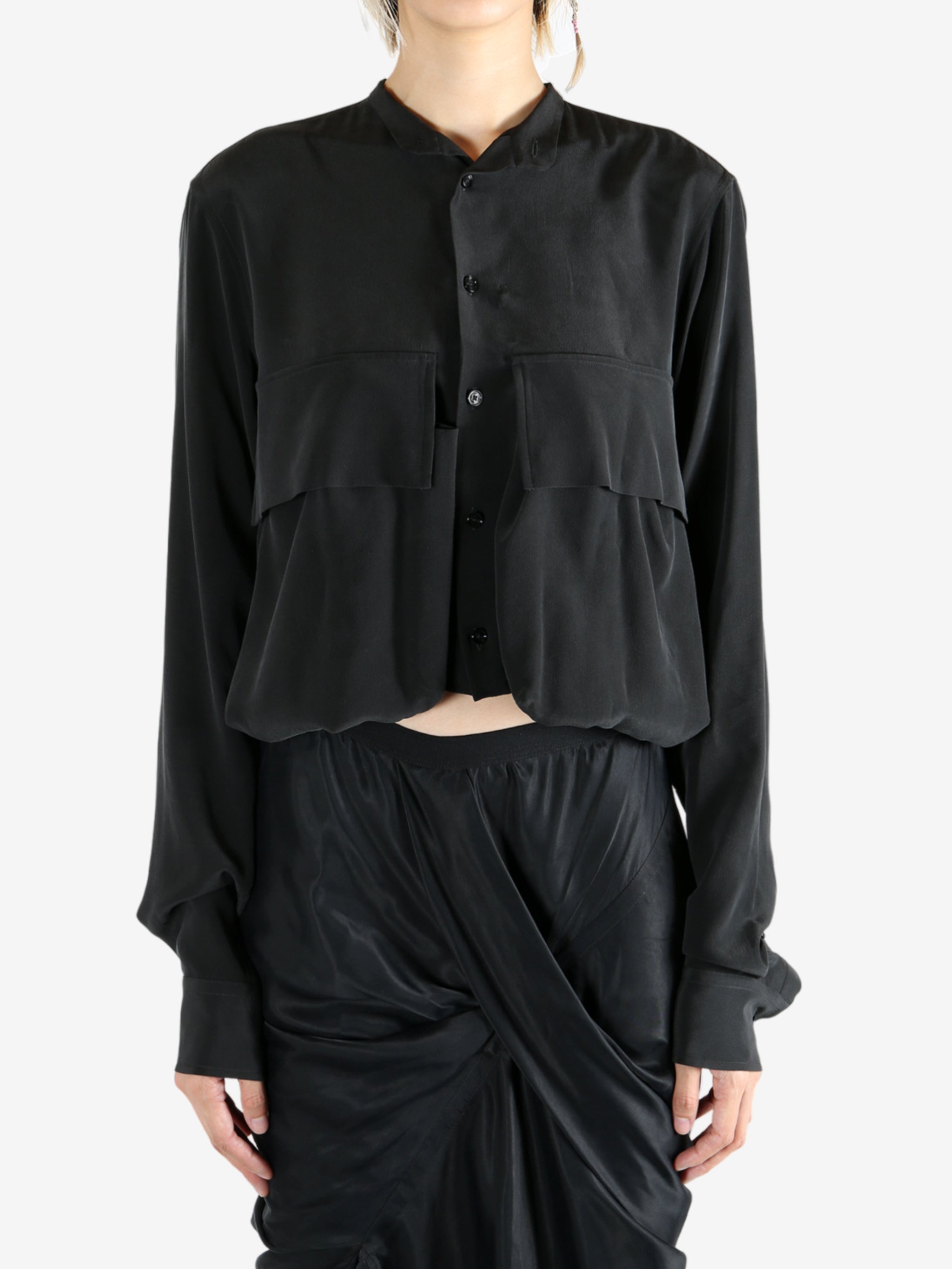 Black shirt worn by a person, showing the shirt's fit