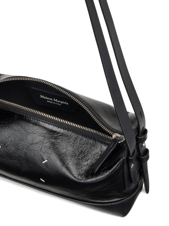 close up of black bags, showing texture of the leather fabric