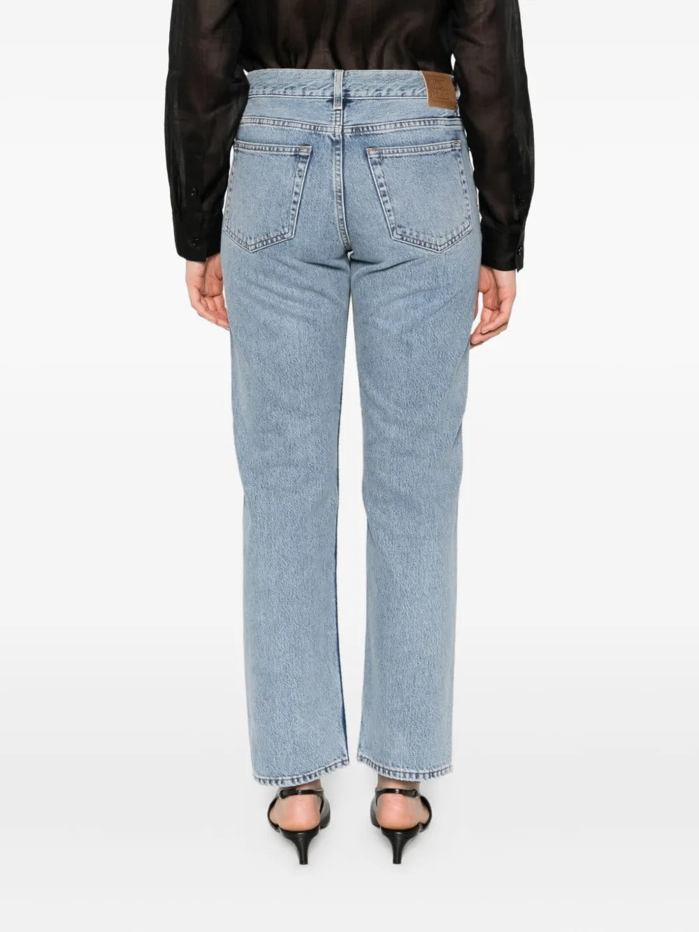 Blue jeans worn by a person, showing the jean's fit