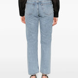 Blue jeans worn by a person, showing the jean's fit