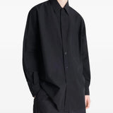 Black shirt worn by a person, showing the shirt's fit