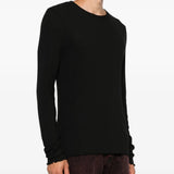 Black knitwear worn by a person, showing the knitwear fit
