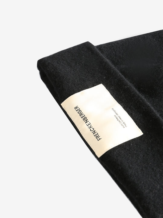 Close up of black hats, showing texture of the wool fabric