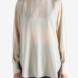 White top worn by a person, showing the top's fit