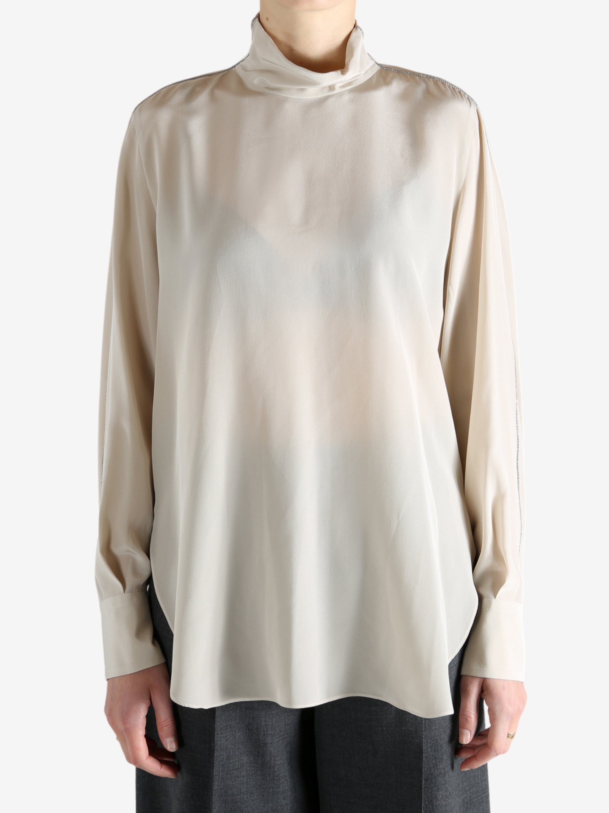 White top worn by a person, showing the top's fit