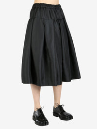 Black skirt worn by a person, showing the skirt's fit