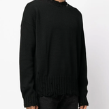 Black sweater worn by a person, showing the sweater's fit