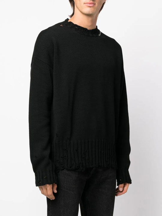 Black sweater worn by a person, showing the sweater's fit