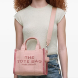 Pink bag, worn by a person, showing the bag's fit