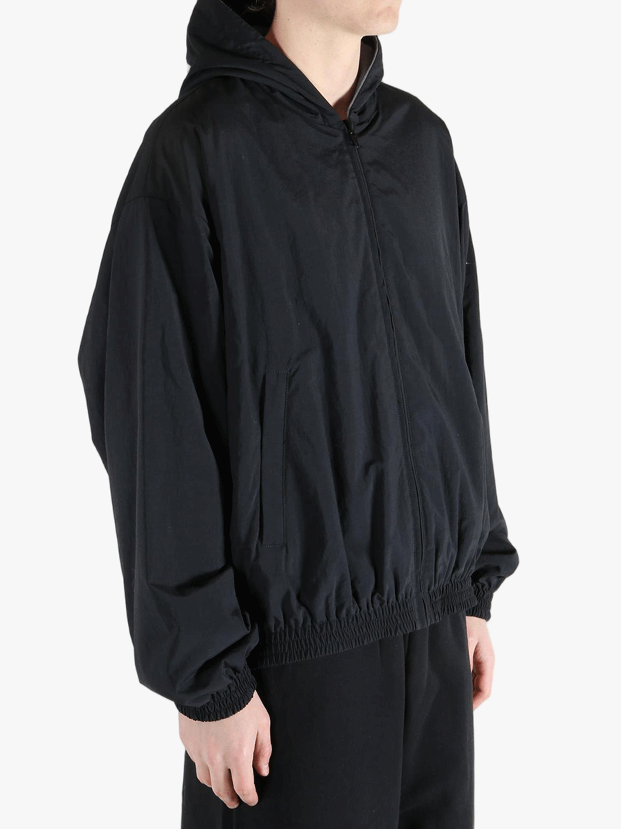 Black jacket worn by a person, showing the jacket's fit