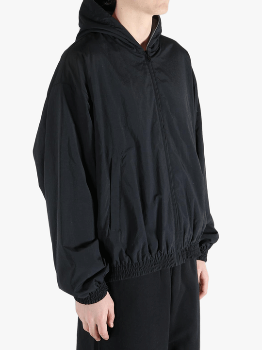 Black jacket worn by a person, showing the jacket's fit