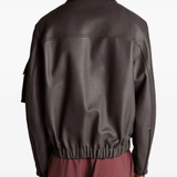 Brown coats worn by a person, showing the coats fit