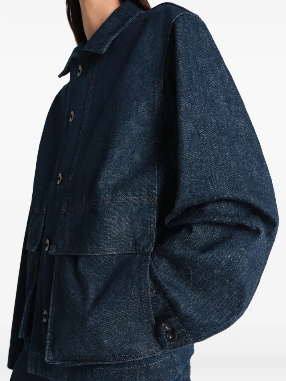 Close up of blue jacket, showing texture of the cotton fabric