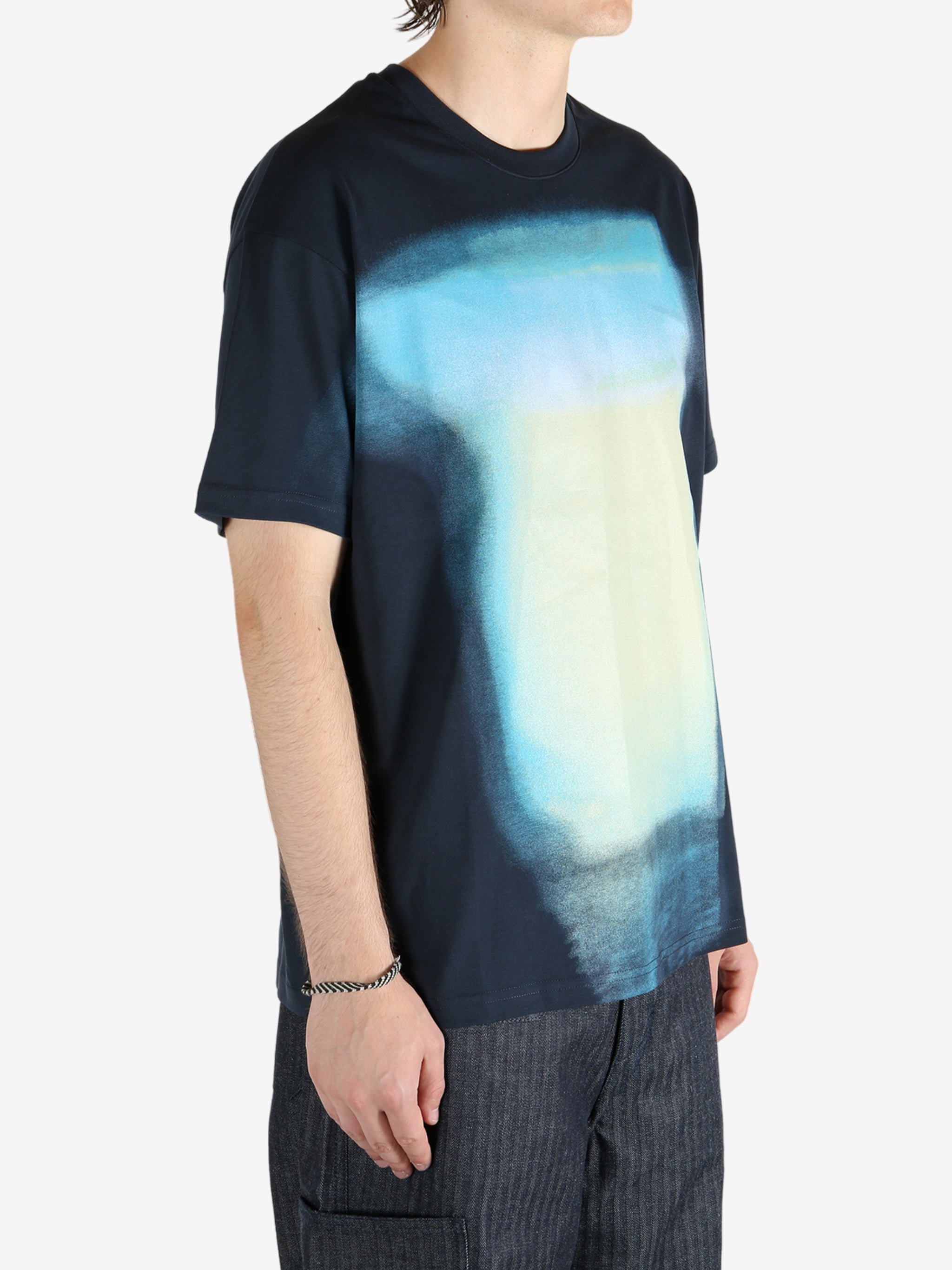 Blue t-shirt worn by a person, showing the shirt fit