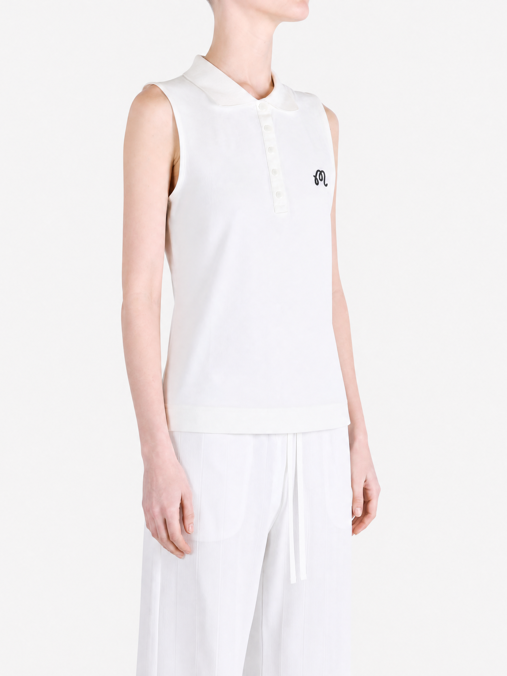 White top worn by a person, showing the top fit
