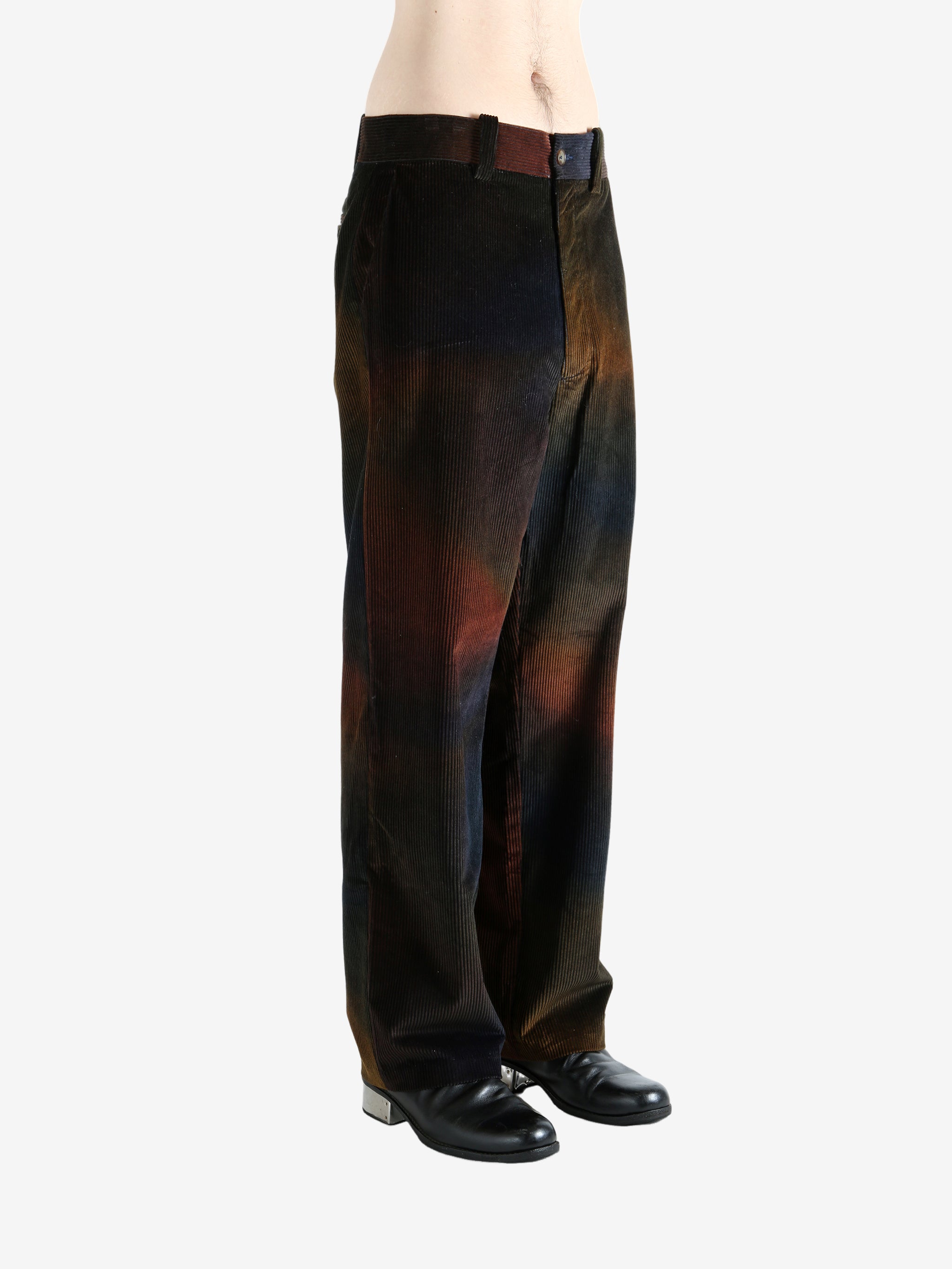 Black pants worn by a person, showing the pants's fit