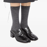 Black shoes worn by a person, showing the shoes fit