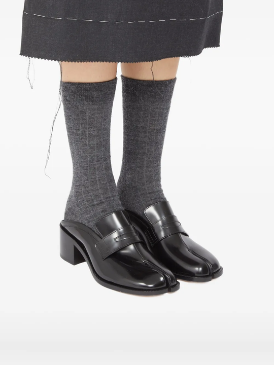 Black shoes worn by a person, showing the shoes fit