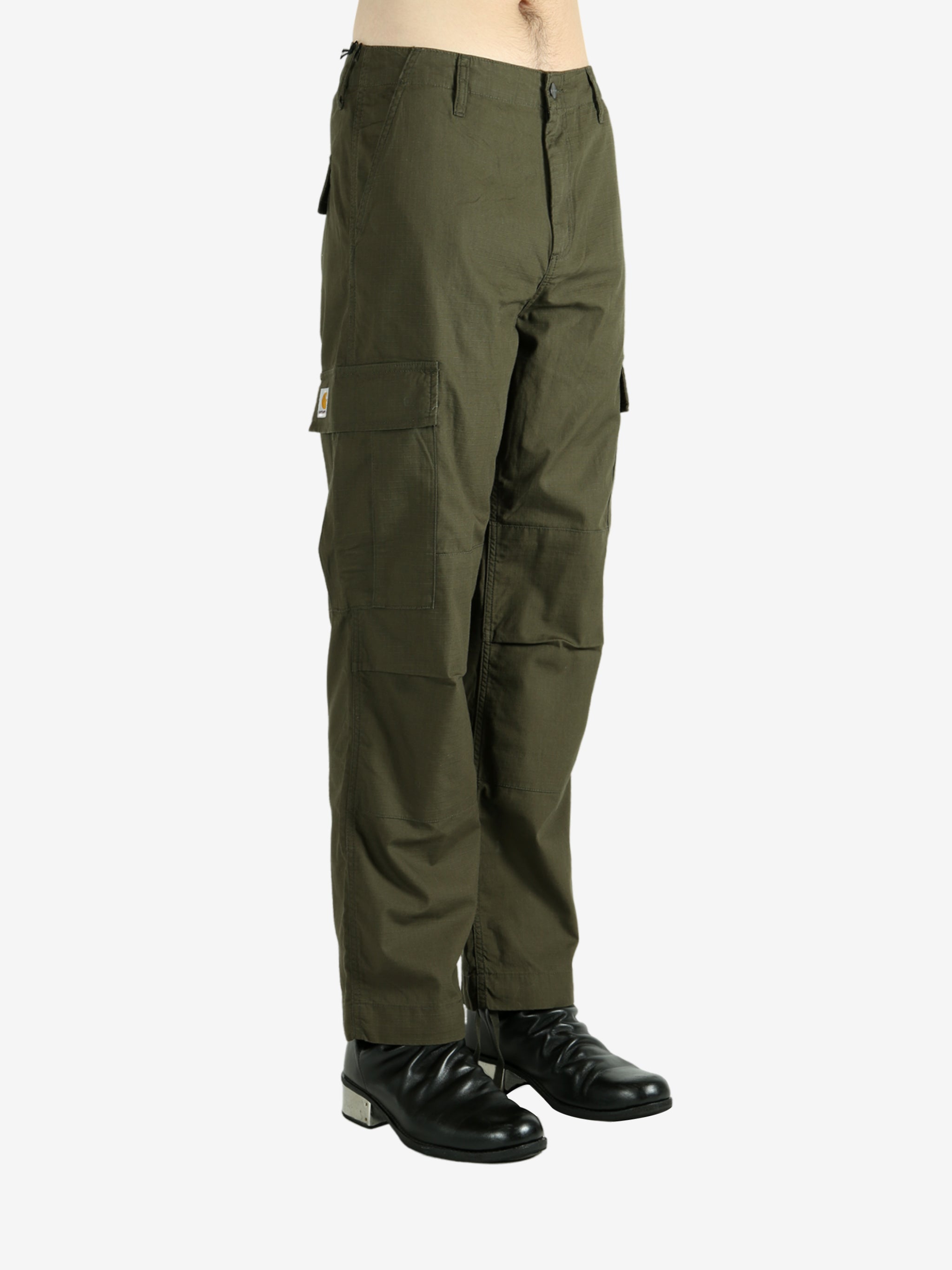 Green pants worn by a person, showing the pants's fit