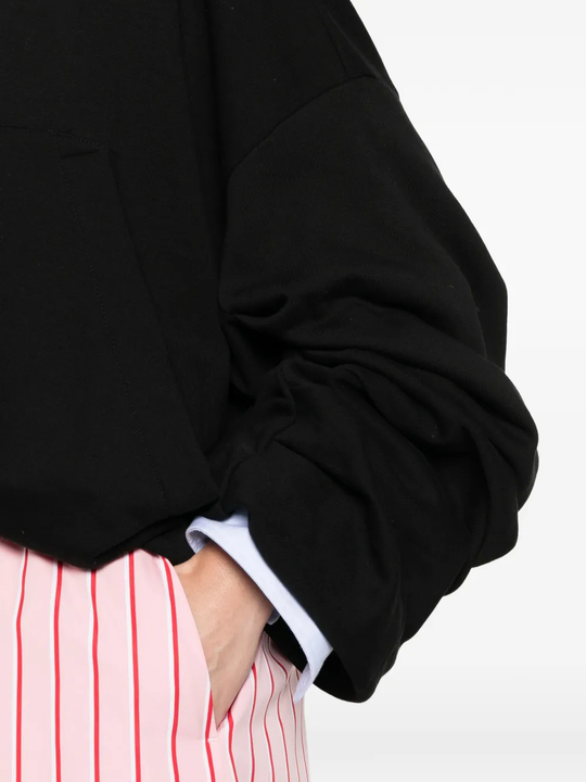 Close up of black jacket, showing texture of the cotton fabric